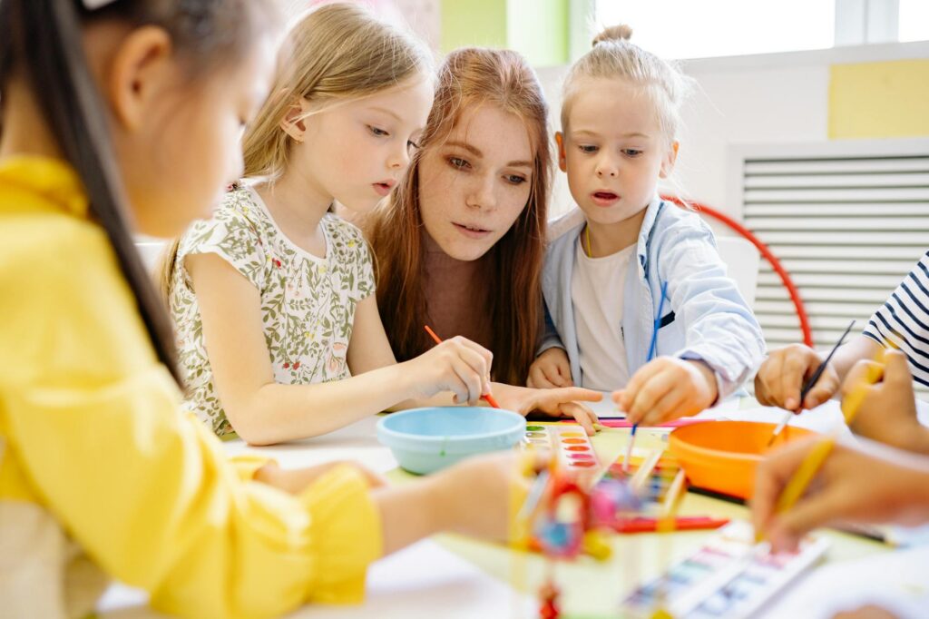 kindergarten teacher children play