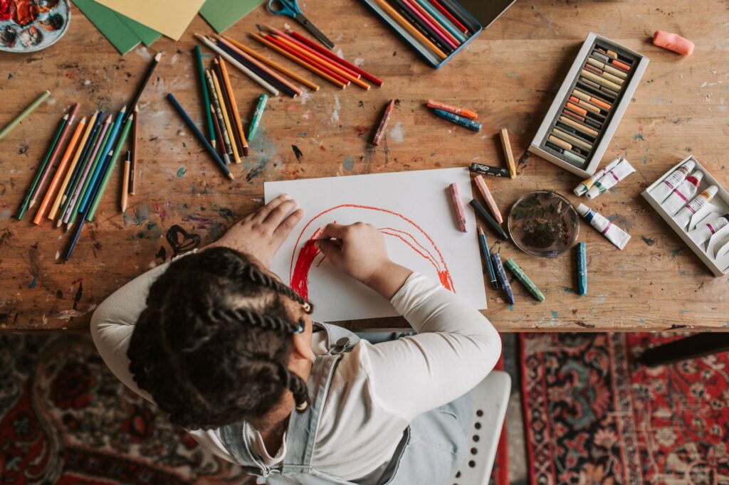 child drawing at desk